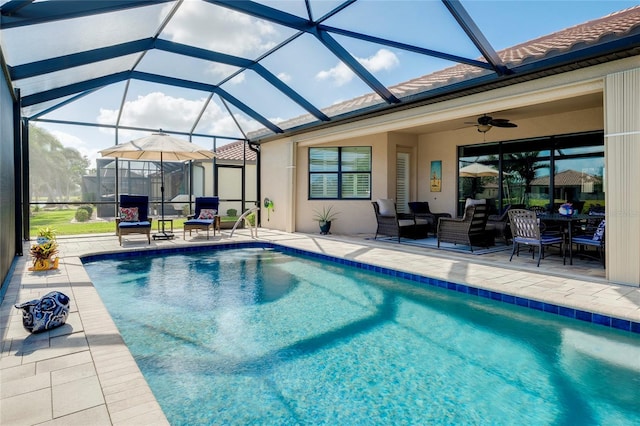 view of pool with a lanai, an outdoor hangout area, ceiling fan, and a patio area