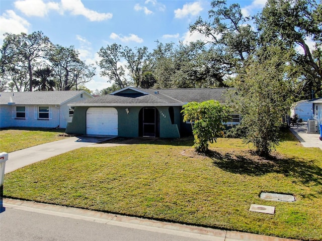 single story home featuring a garage and a front lawn