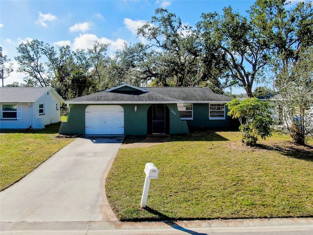 single story home with a garage and a front lawn