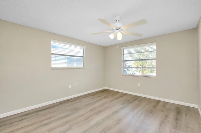 spare room with light hardwood / wood-style flooring and ceiling fan