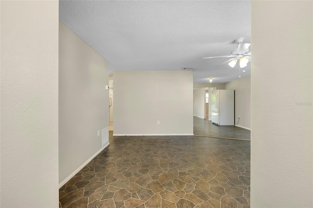 spare room featuring a textured ceiling and ceiling fan