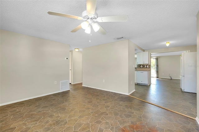 unfurnished living room featuring ceiling fan and a textured ceiling