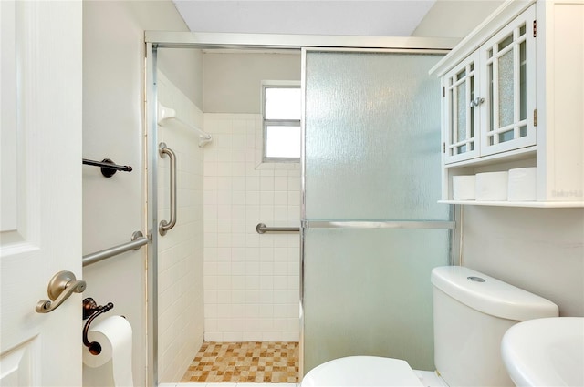 bathroom with an enclosed shower and toilet