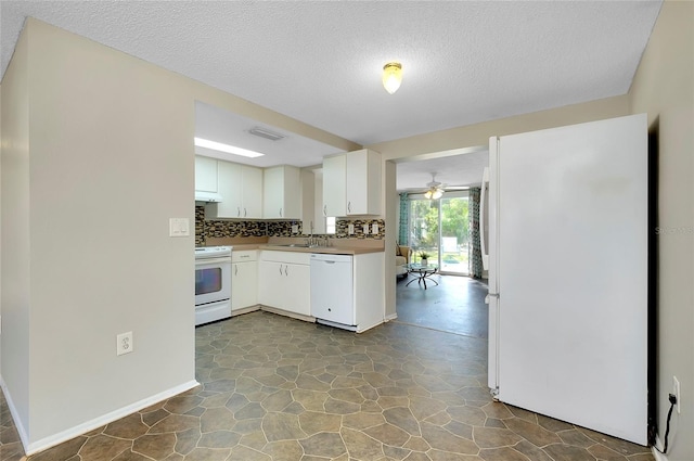 kitchen featuring sink, white appliances, white cabinetry, tasteful backsplash, and a textured ceiling