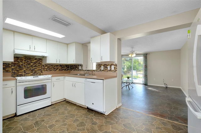 kitchen with sink, tasteful backsplash, a textured ceiling, white appliances, and white cabinets