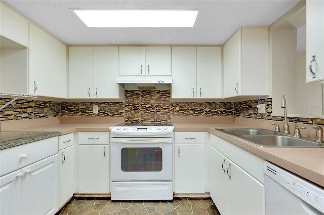 kitchen with sink, white appliances, white cabinets, and backsplash