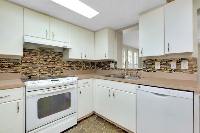 kitchen with sink, white appliances, white cabinetry, tile patterned flooring, and backsplash