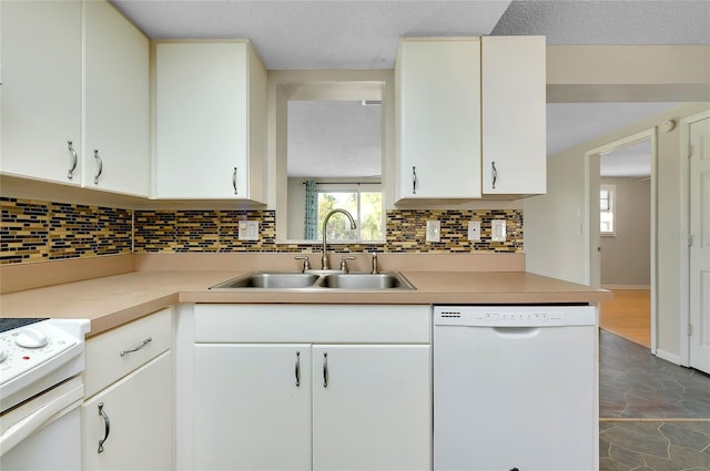 kitchen with sink, white appliances, a textured ceiling, white cabinets, and decorative backsplash