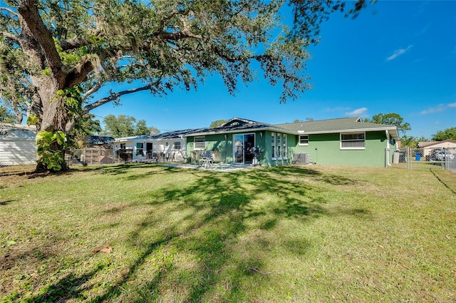 back of property featuring a patio, a yard, and central air condition unit