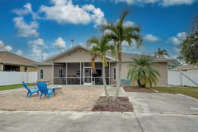 back of house featuring a sunroom and a patio area