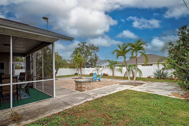 view of yard featuring a sunroom and a patio