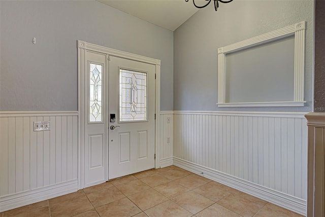 foyer entrance featuring a chandelier and light tile patterned flooring