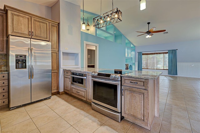 kitchen featuring light stone countertops, appliances with stainless steel finishes, ceiling fan, light tile patterned floors, and high vaulted ceiling