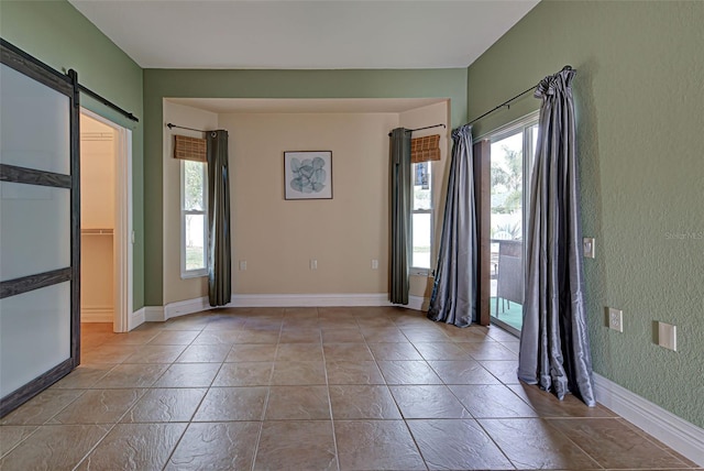 spare room with a barn door