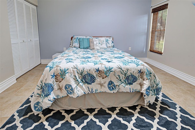 tiled bedroom with a closet