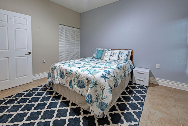 tiled bedroom with a closet