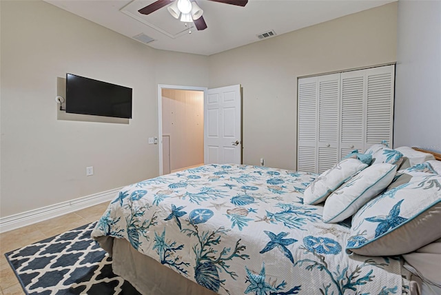 bedroom featuring tile patterned flooring, ceiling fan, and a closet