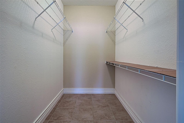 walk in closet with tile patterned flooring