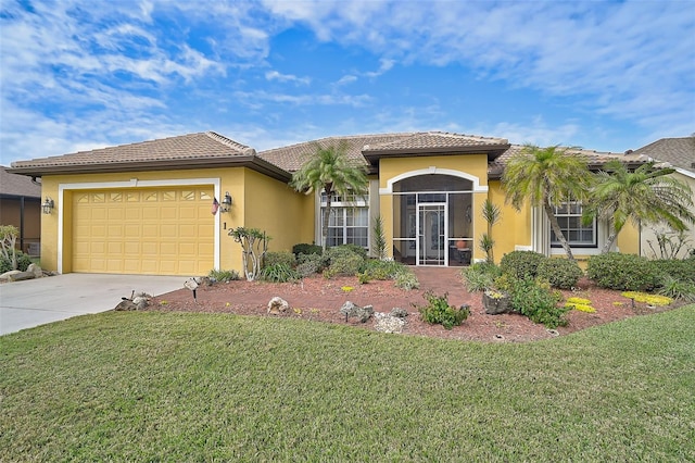 mediterranean / spanish-style house featuring a front yard and a garage