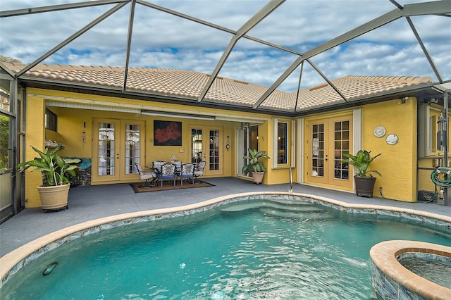 view of pool featuring french doors, a patio, and a lanai