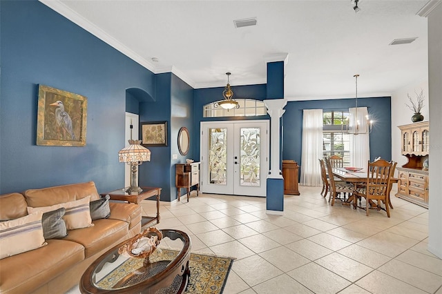 living room featuring crown molding, french doors, light tile patterned floors, and an inviting chandelier