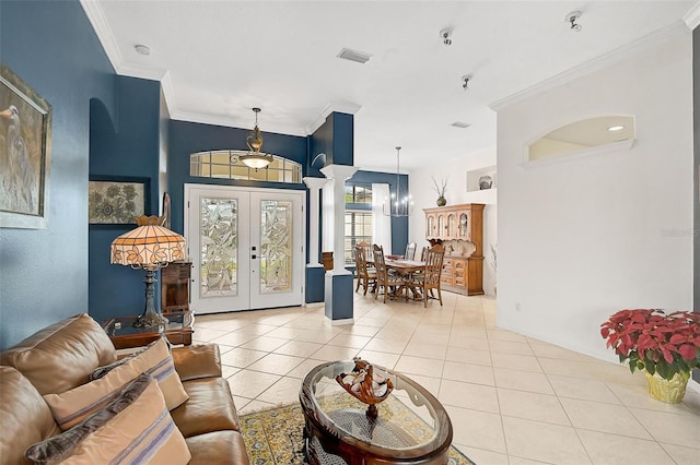 tiled living room featuring crown molding, french doors, and a chandelier