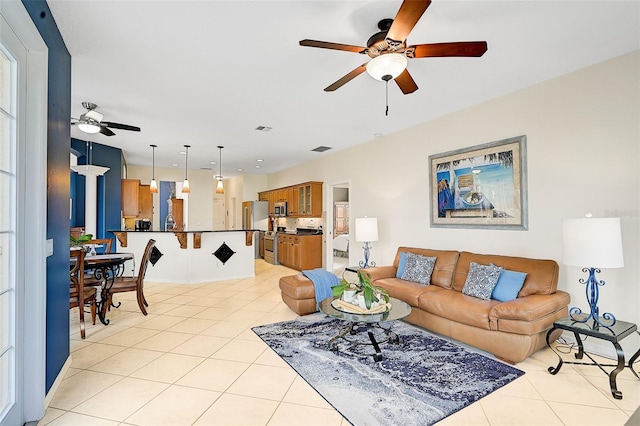 tiled living room featuring ceiling fan