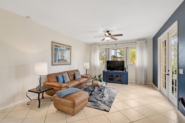 tiled living room featuring french doors and ceiling fan