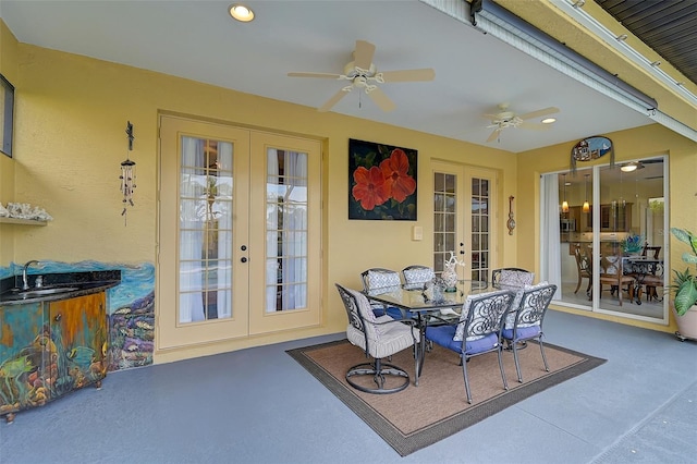 sunroom with ceiling fan, french doors, and sink