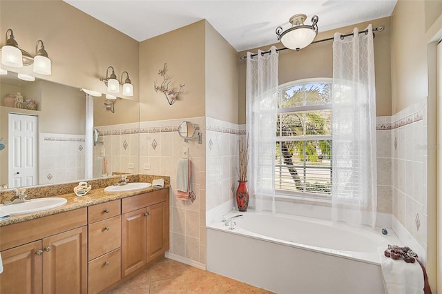 bathroom with tile patterned flooring, vanity, and tile walls