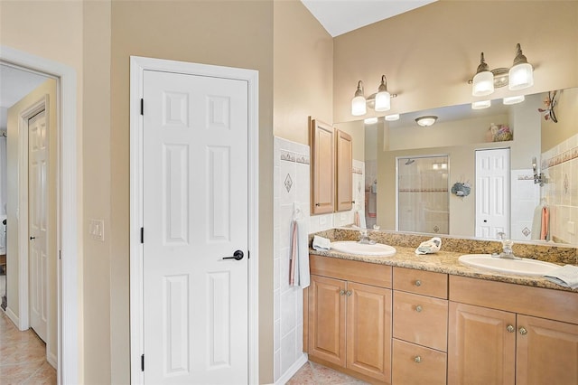 bathroom with tile patterned flooring, vanity, and a shower with shower door