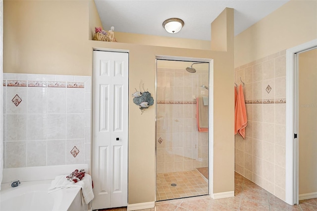 bathroom with tile patterned flooring and independent shower and bath