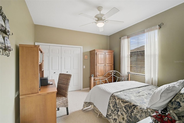 carpeted bedroom featuring ceiling fan and a closet