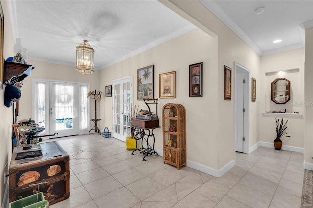 foyer with light tile patterned flooring, french doors, ornamental molding, and a notable chandelier