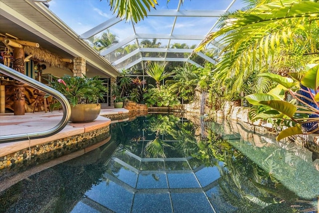 view of swimming pool with glass enclosure