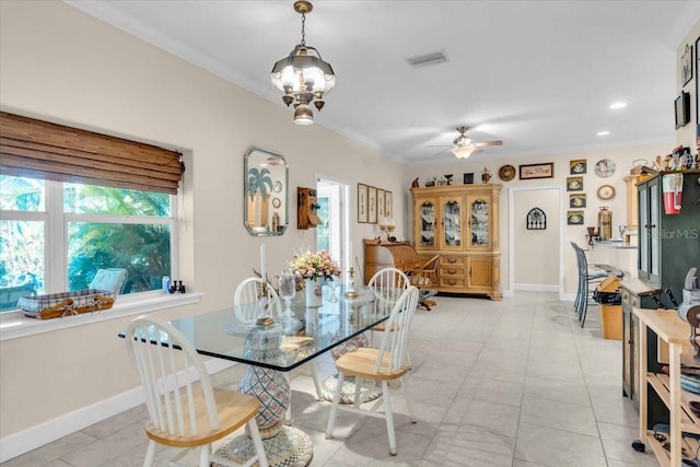 dining space with ceiling fan with notable chandelier and ornamental molding