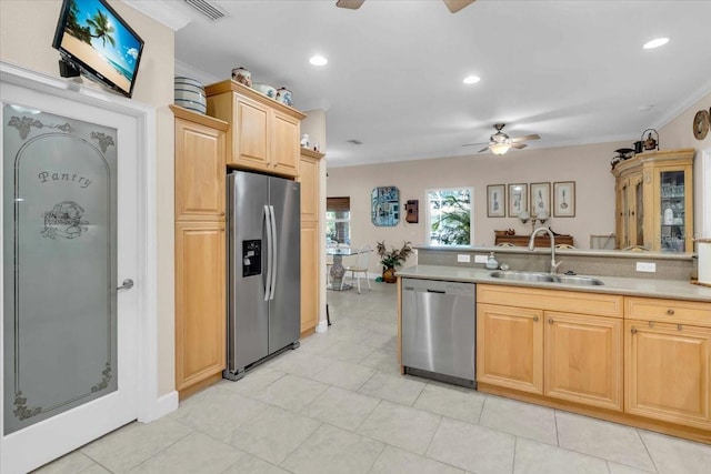 kitchen featuring crown molding, ceiling fan, sink, and stainless steel appliances