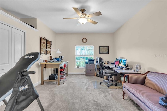 office area featuring light carpet and ceiling fan