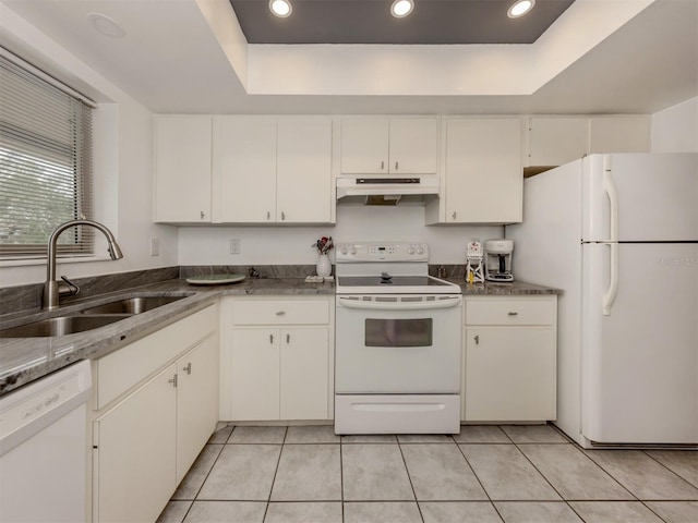 kitchen with white cabinets, white appliances, sink, and a tray ceiling