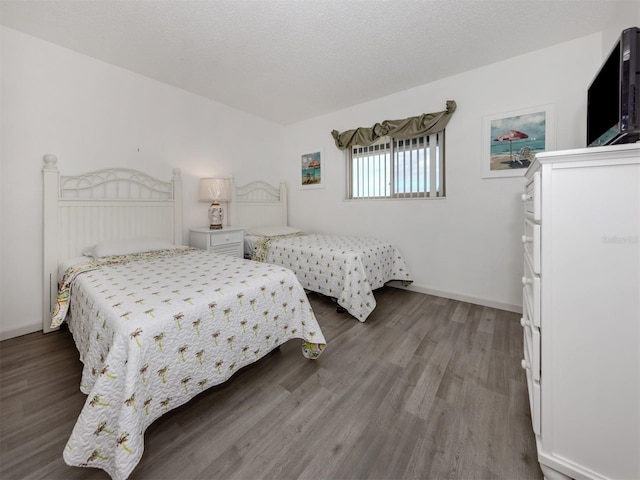 bedroom featuring a textured ceiling and hardwood / wood-style flooring