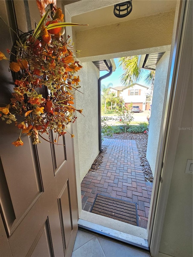 entryway with light tile patterned floors