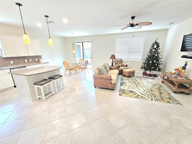 living room featuring ceiling fan and light tile patterned floors