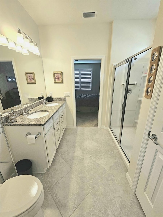 bathroom featuring tile patterned floors, an enclosed shower, and vanity