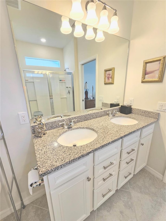 bathroom with tile patterned flooring, an enclosed shower, and vanity