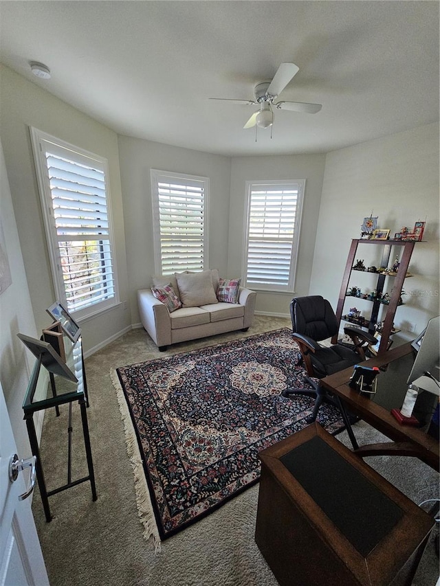 carpeted living room featuring ceiling fan