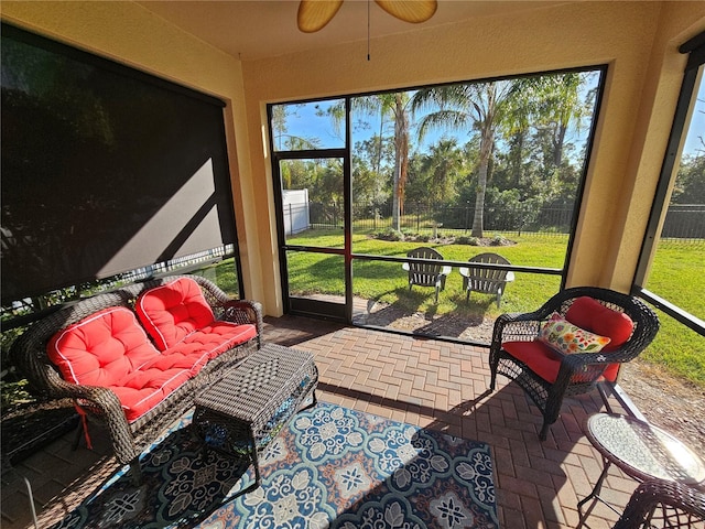 sunroom featuring ceiling fan