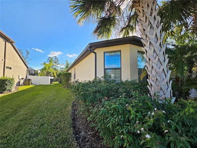 view of property exterior with a yard