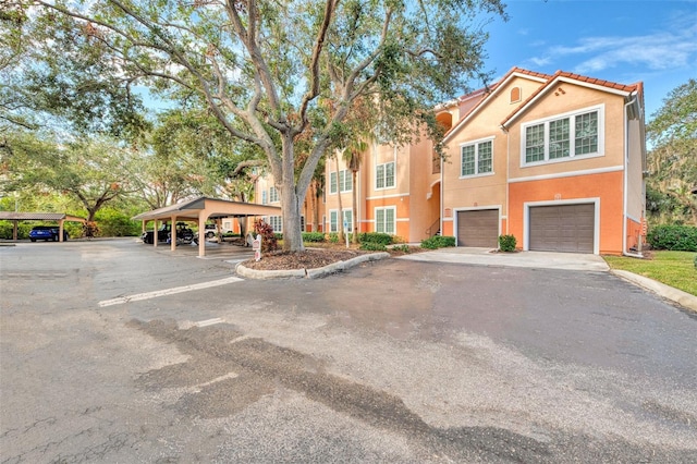 view of front of property featuring a carport and a garage