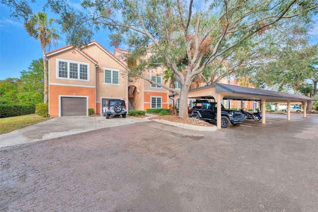 view of front of property with a carport and a garage