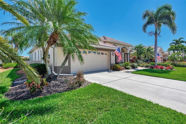 mediterranean / spanish-style home featuring a garage and a front lawn